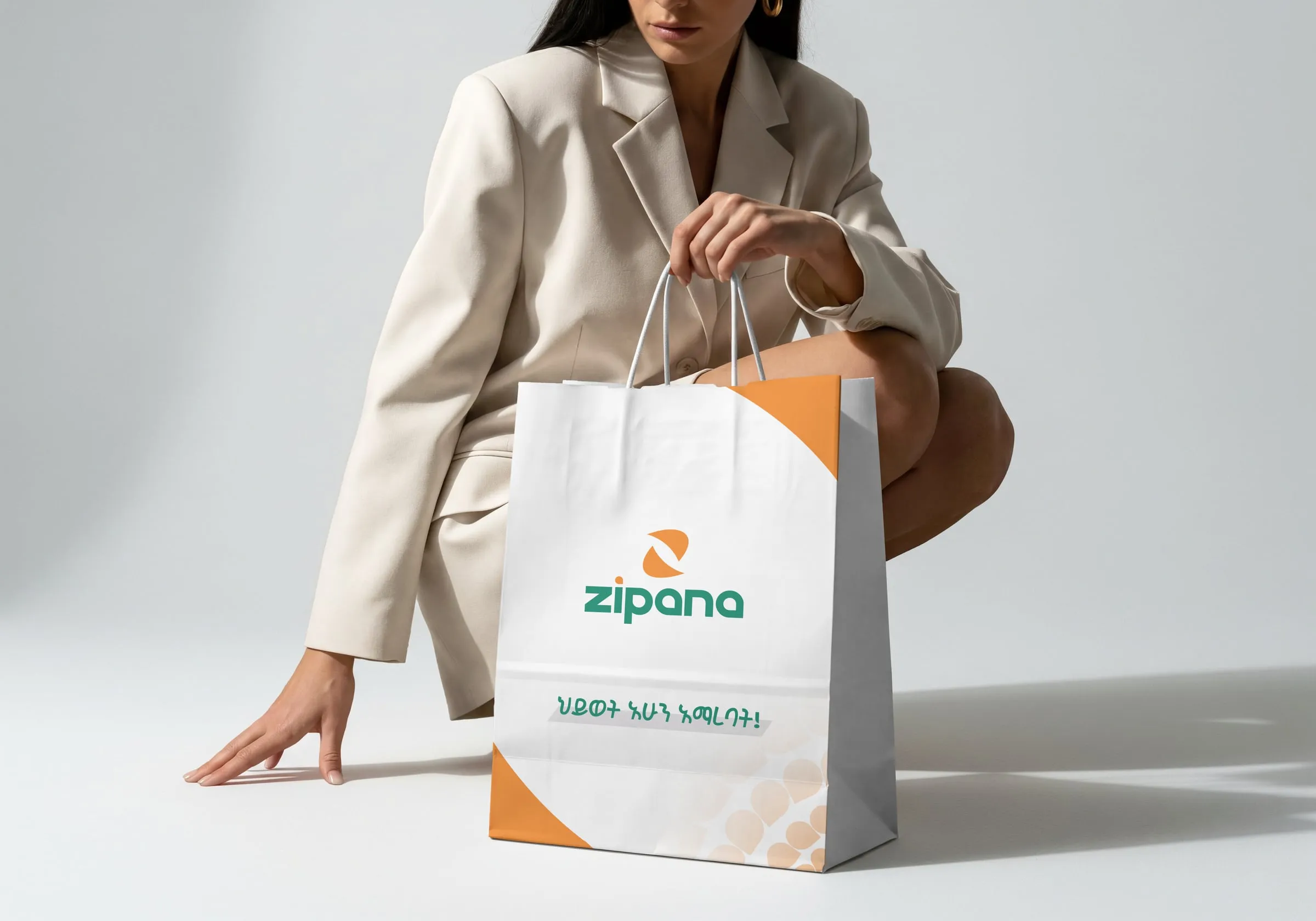 A woman holding a white Zipana shopping bag