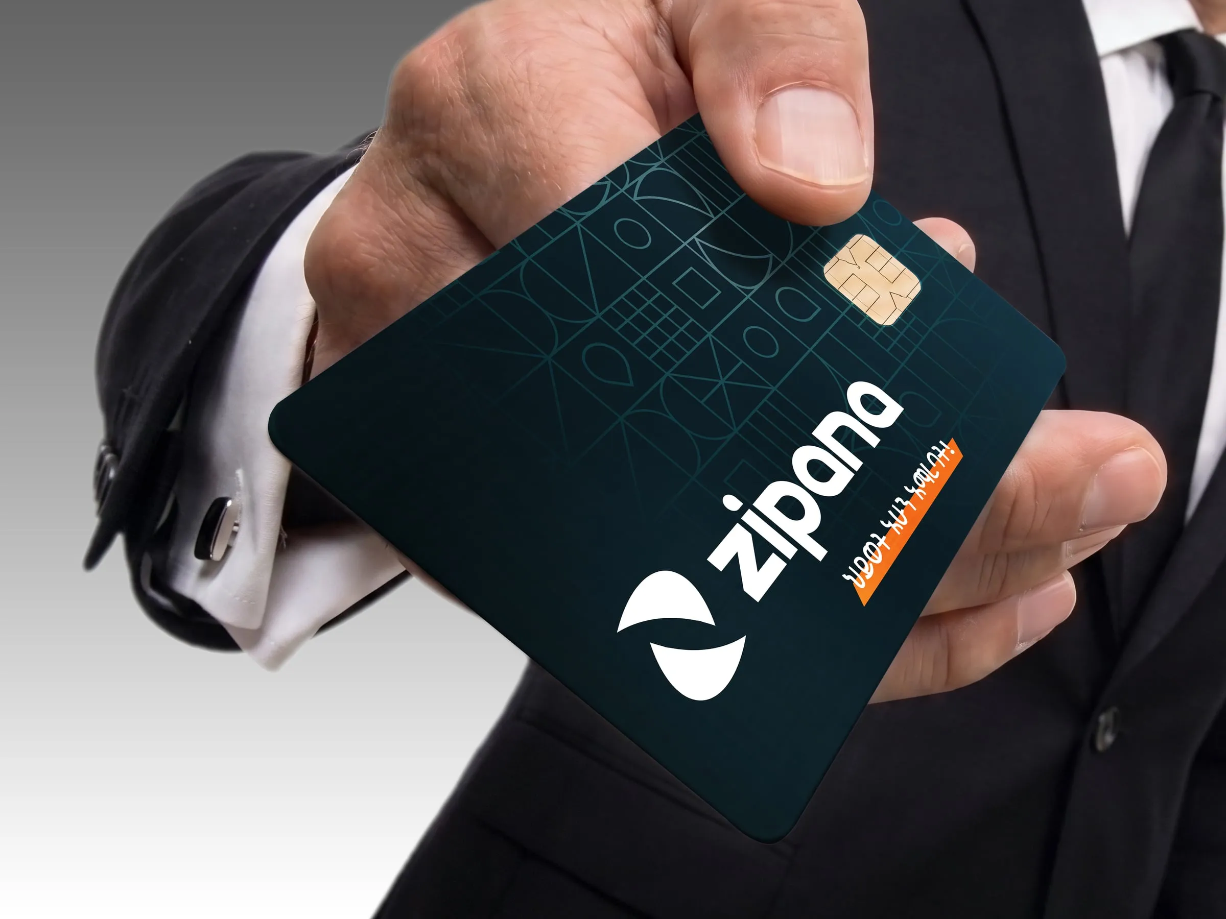 A hand holding out a dark Zipana card
